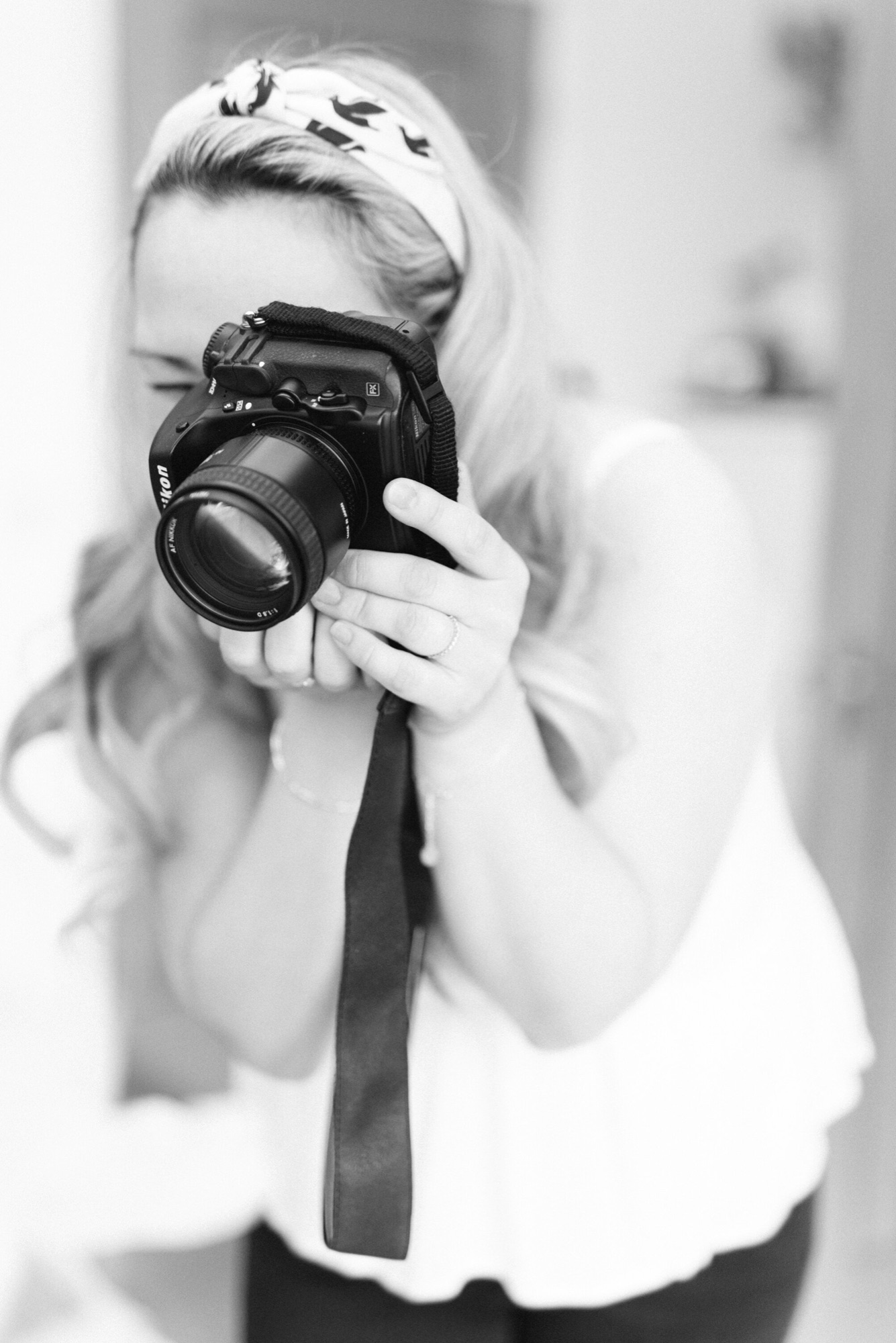 Black and white photo of Kiki holding her camera