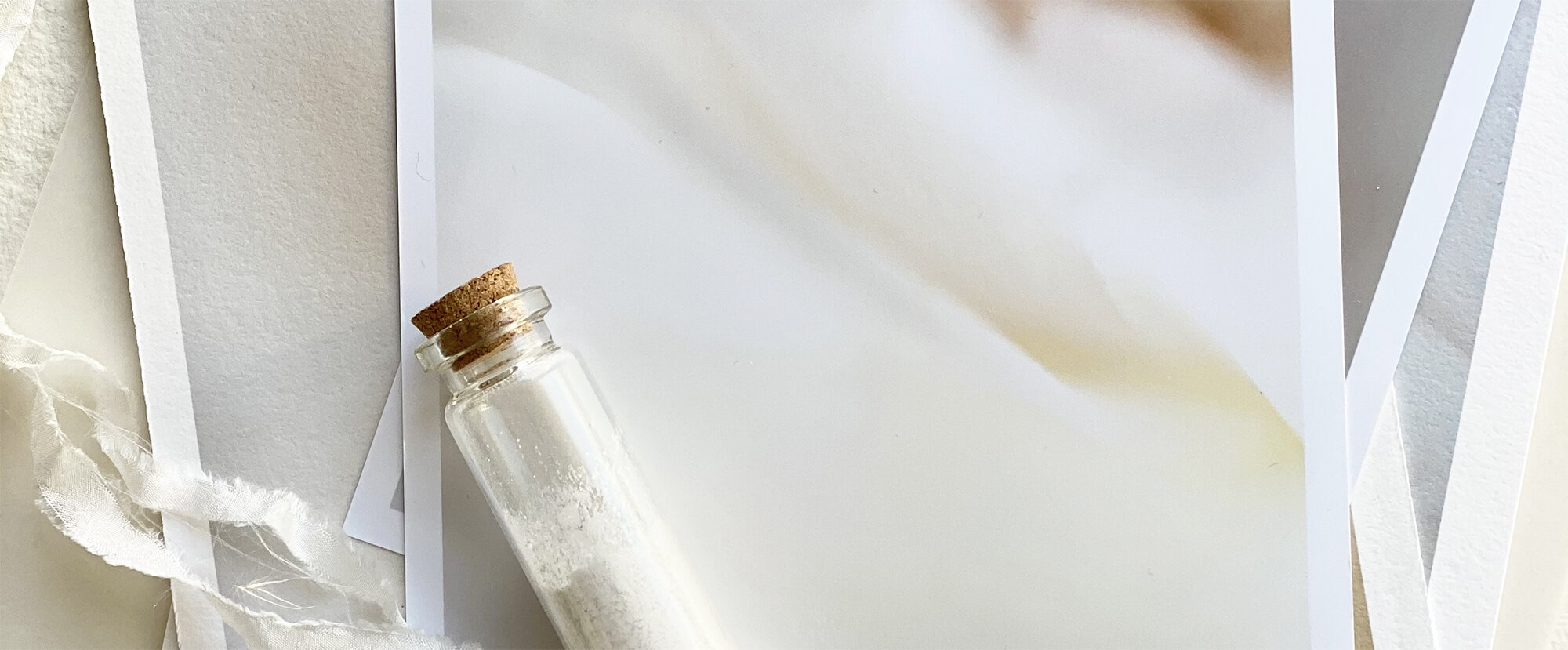 Fine art print on a table with a small cork-stoppered glass bottle