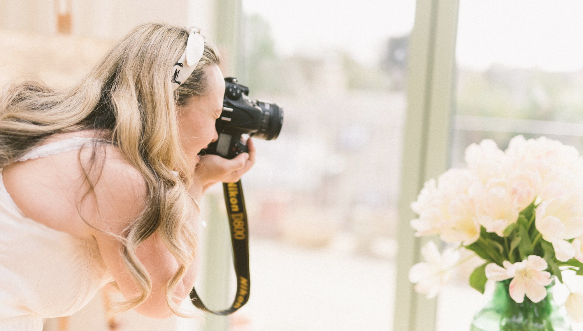 Kiki photographing white peonies with her camera